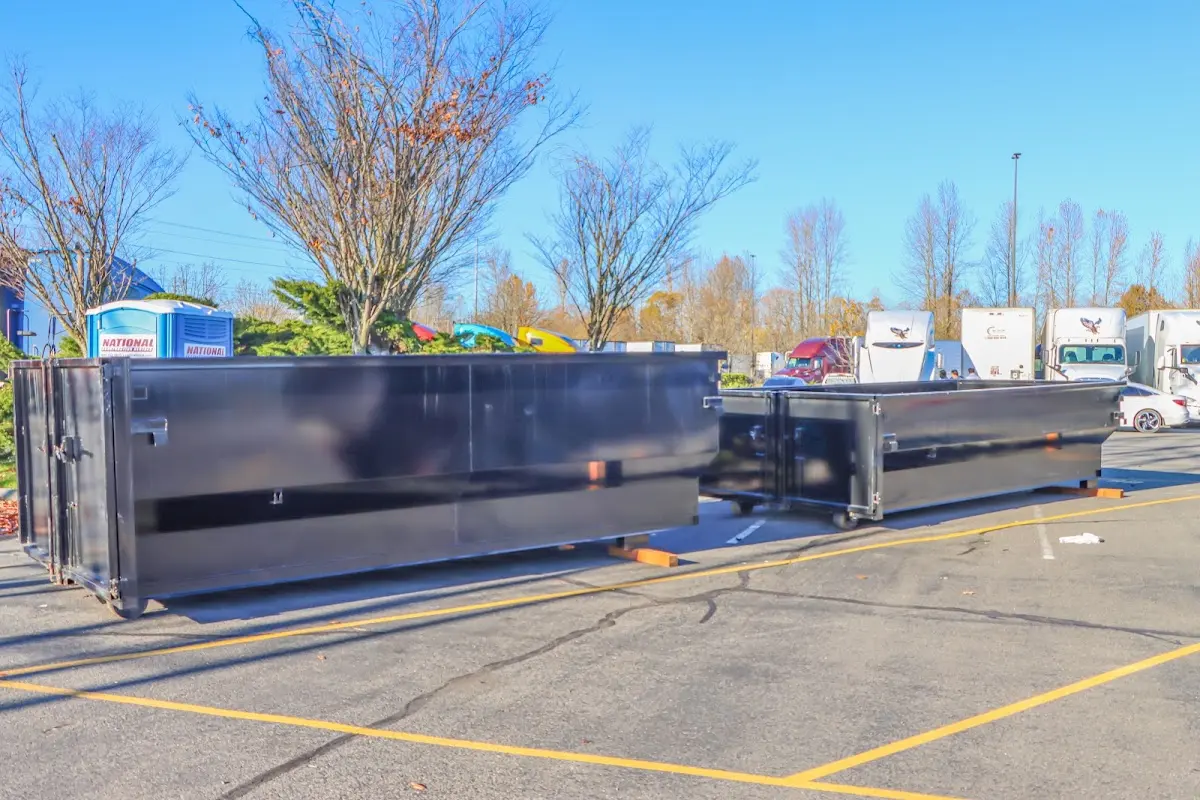 Professional dumpster rental service with roll-off container on residential driveway in Minneapolis